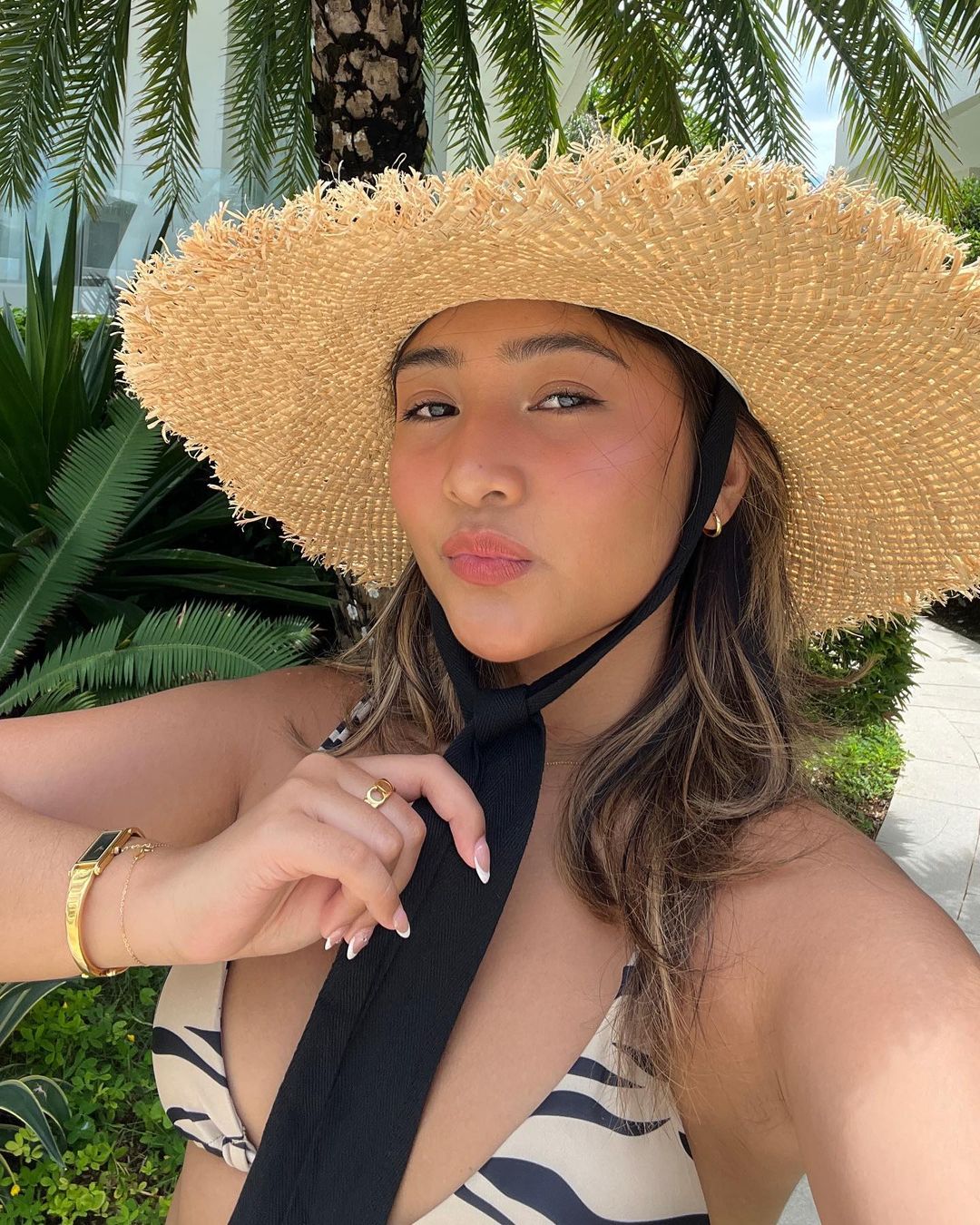 Ry Velasco wearing straw hat