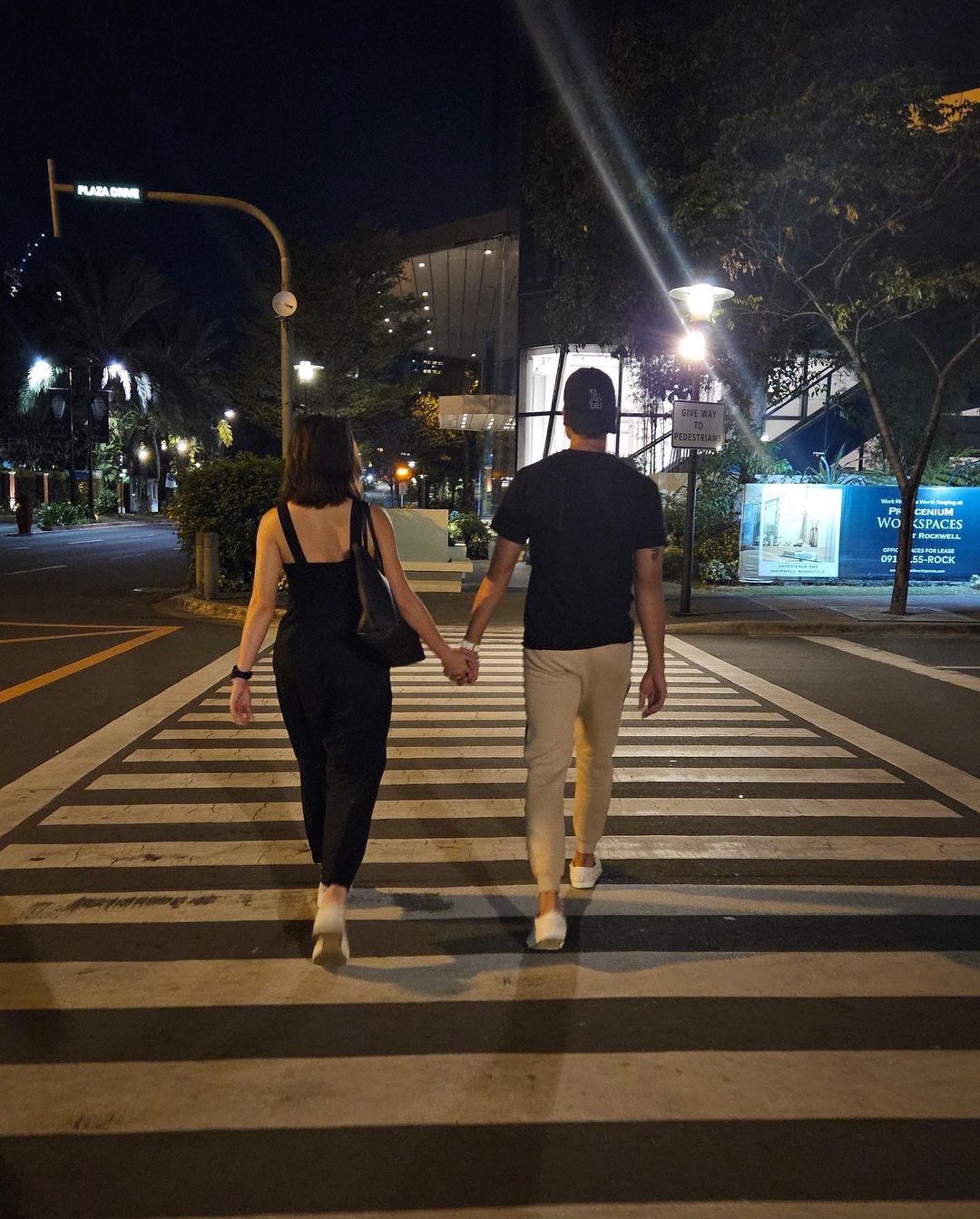 Cristine Reyes and Marco Gumabao hold hands while crossing the street