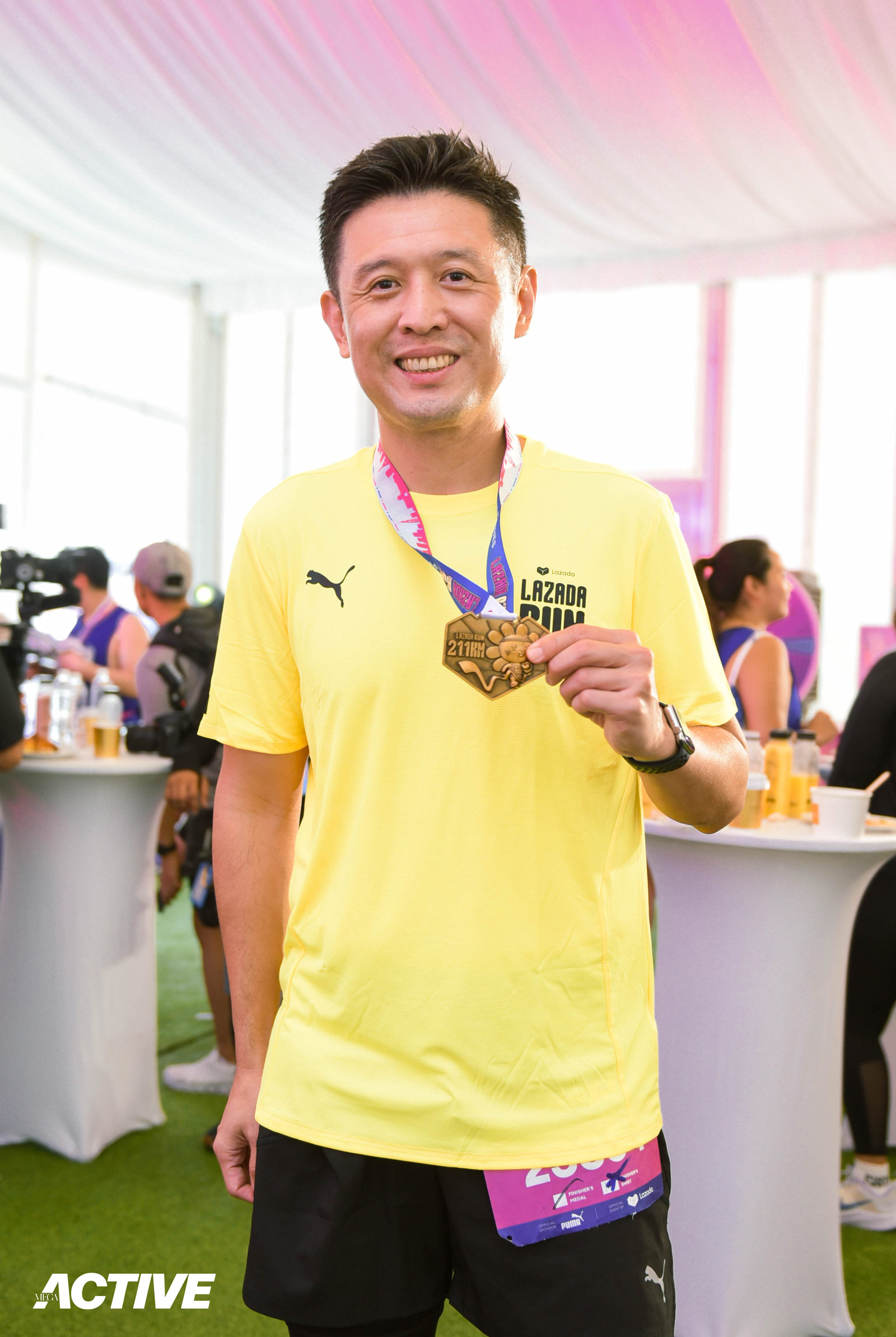 Lazada's Chief Marketing Officer, Marcus Chew, showed off his 21km medal with a smile in Lazada Run PH 
