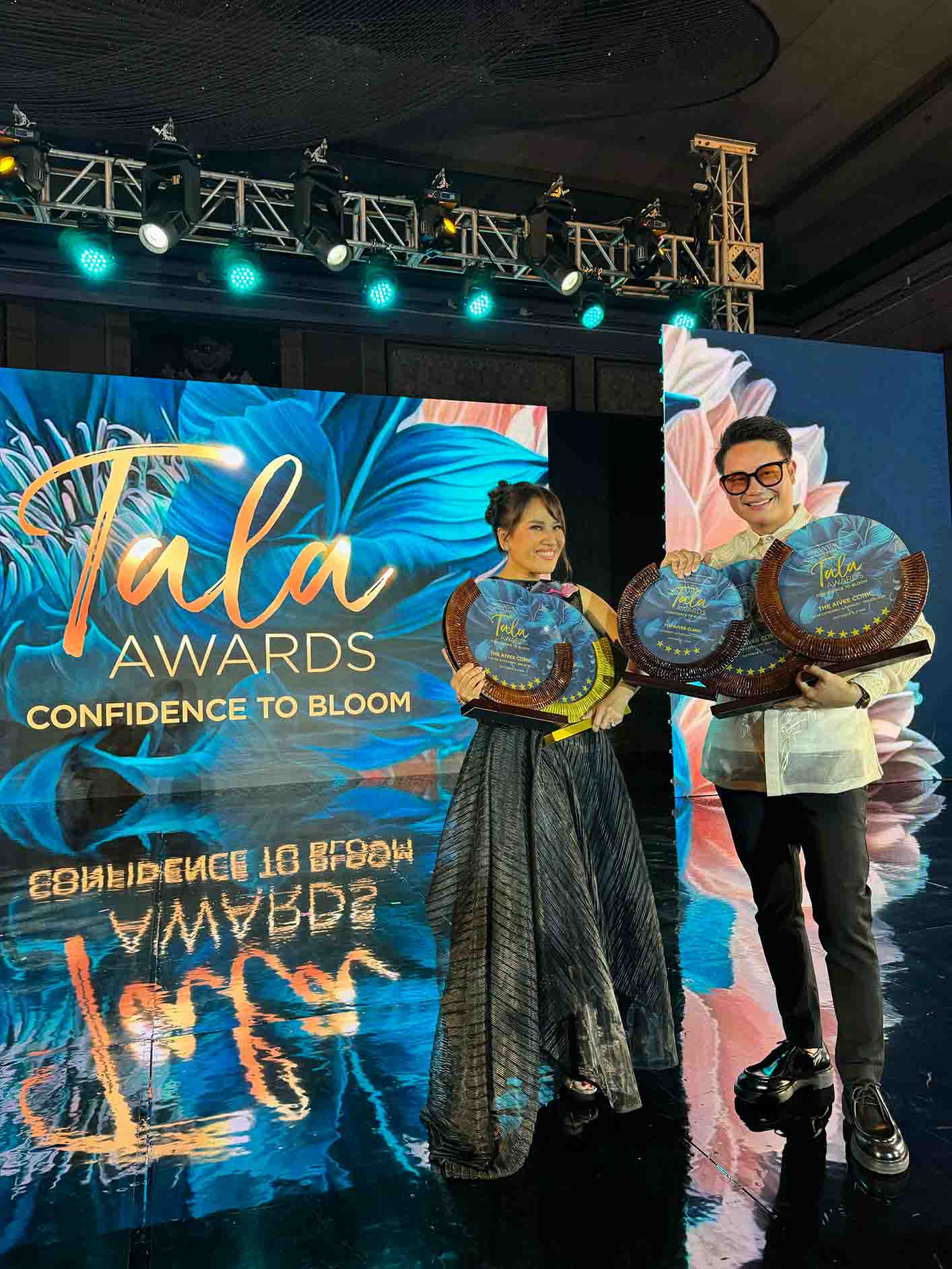 Dr. Z and Aivee Teo sharing a look of happiness with their awards