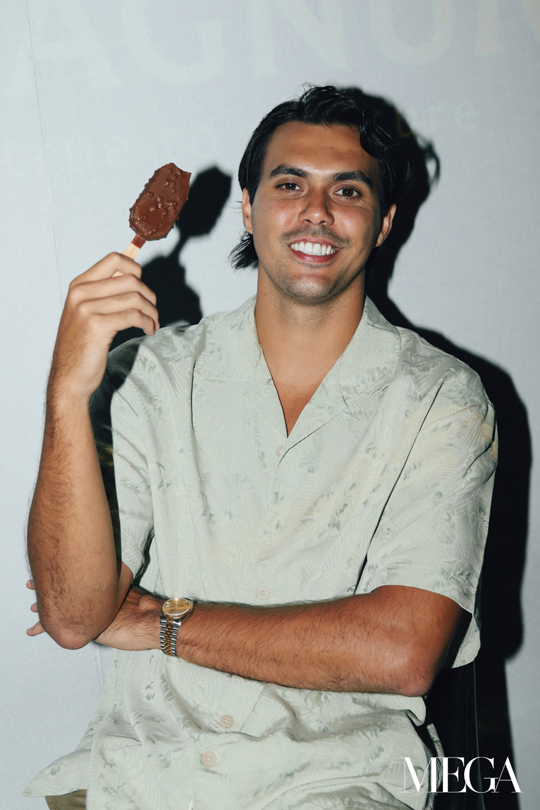 Daniel Peters charmingly smiles at the camera after taking an ice cream bite