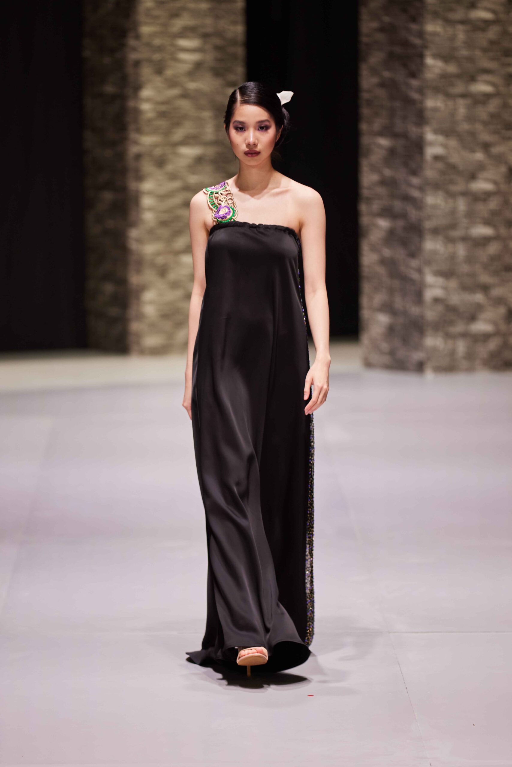 A tube dress with an embellished strap