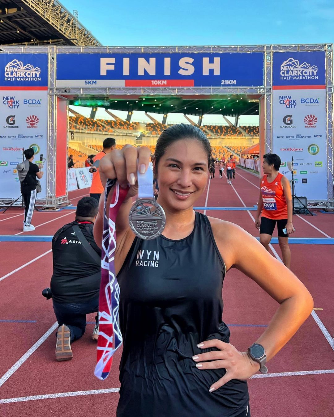 Bubbles Paraiso holding up a medal