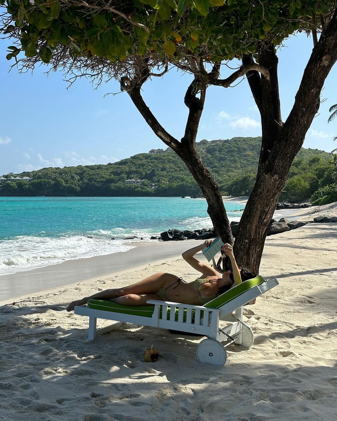 Kendall Jenner reading in the beach