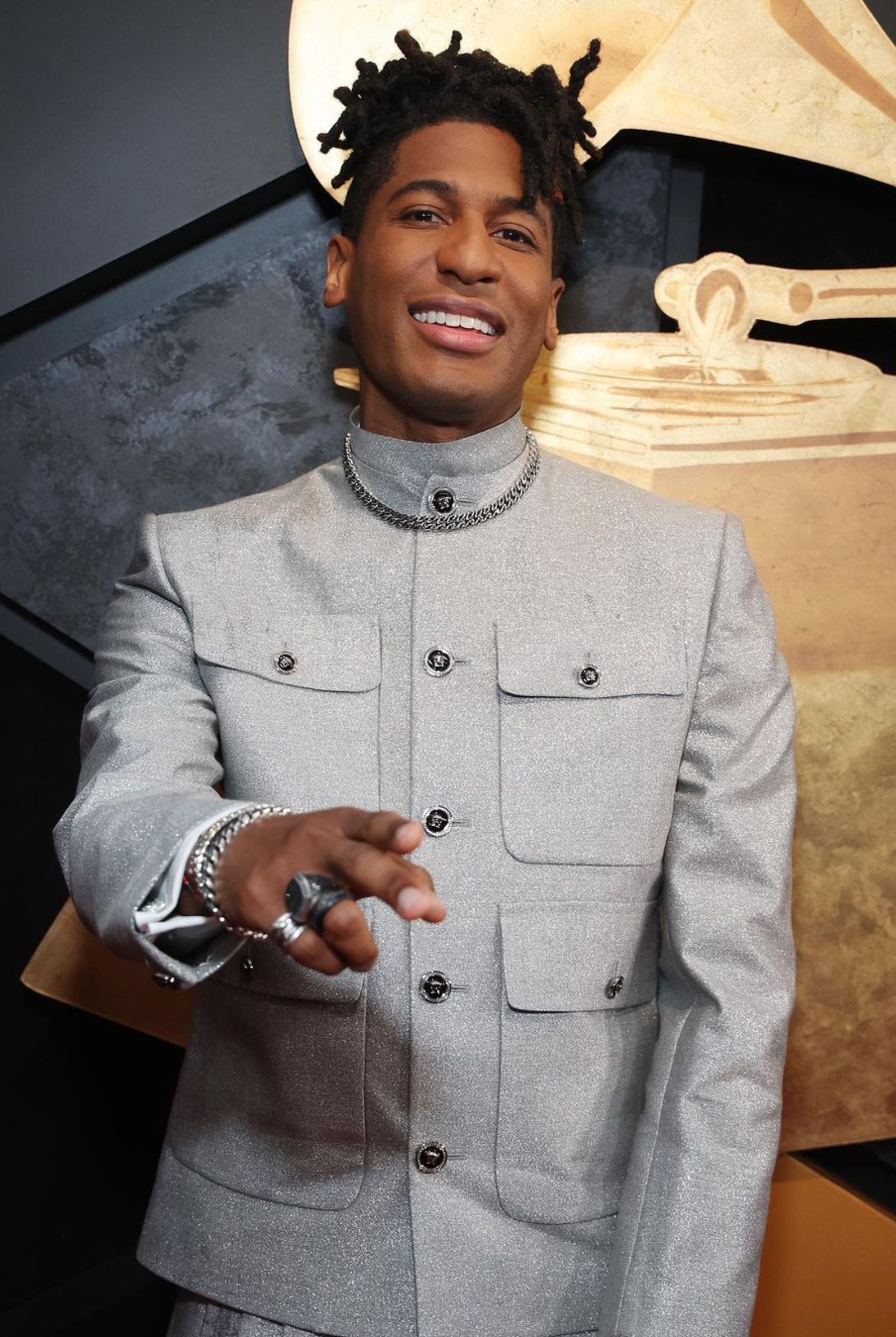 Jon Baptiste keeps it sharp in a metallic gray jacket and kilt