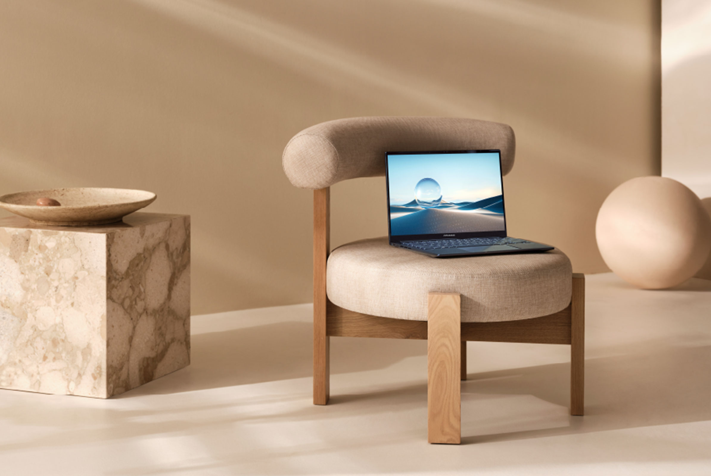 The ASUS Zenbook 14 OLED placed on a chair
