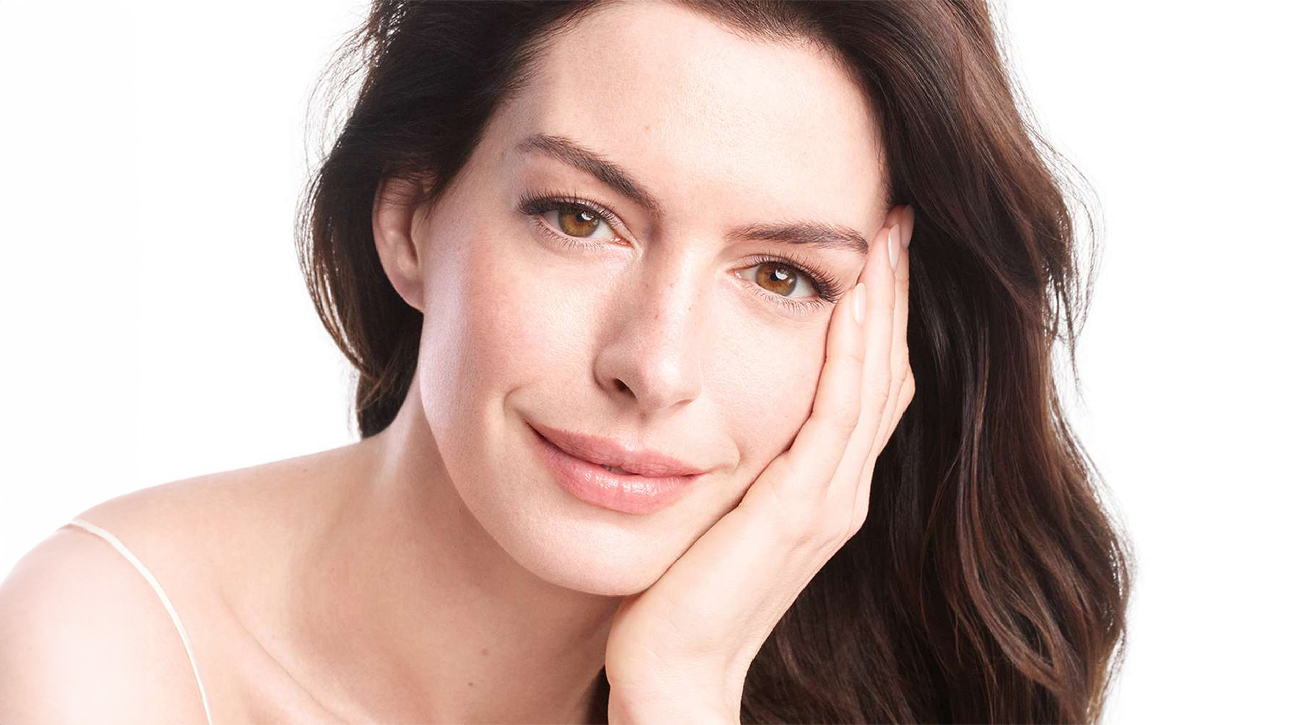 Anne Hathaway photographed in front of a white background