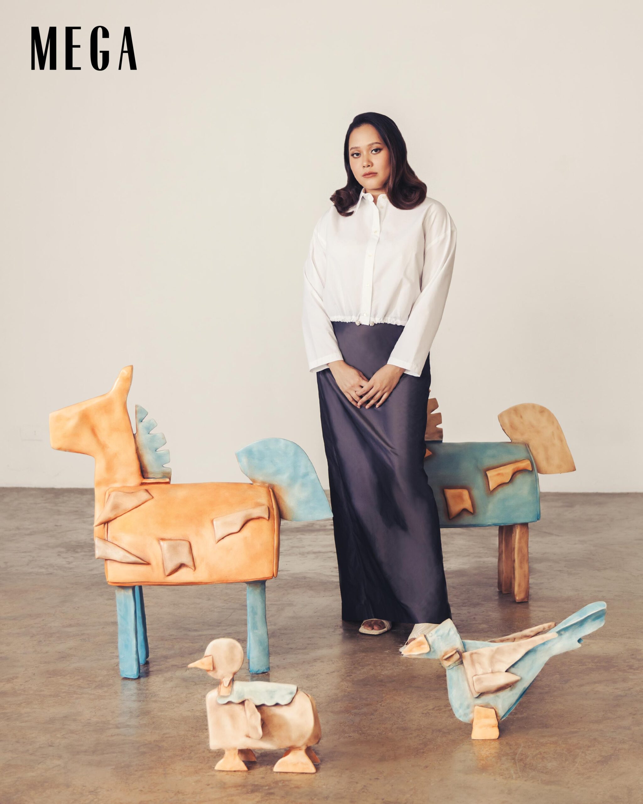 Ayka Go in her Play House exhibit, wearing a MANGO top and skirt, and EDYA1929 heels