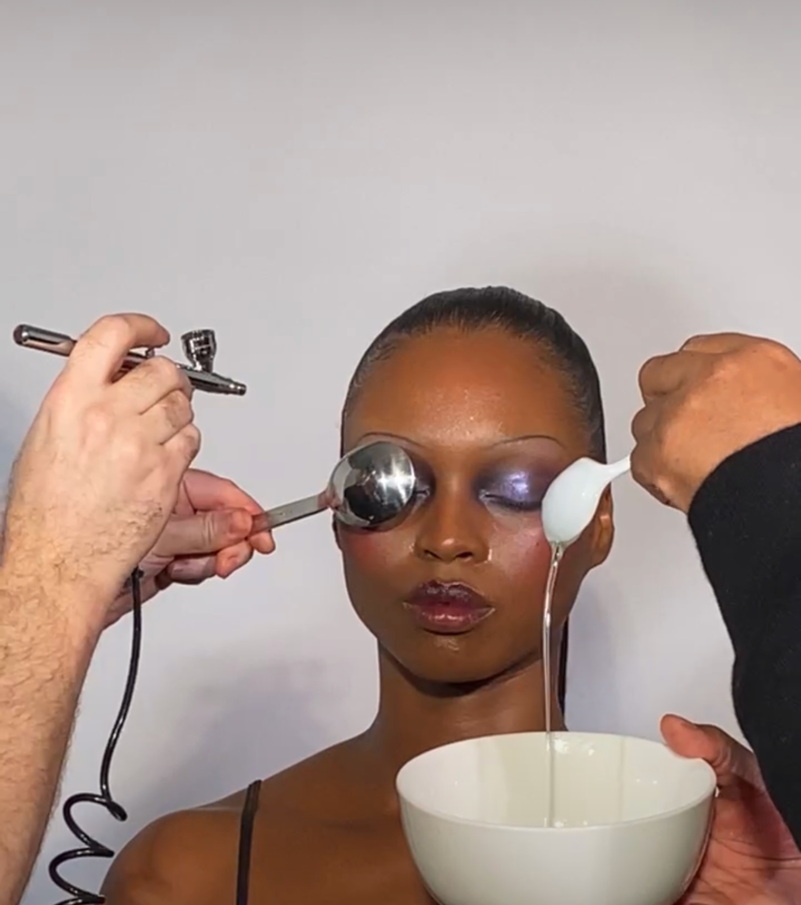 Team Pat McGrath airbrushing LaPorcshia using their unique blend