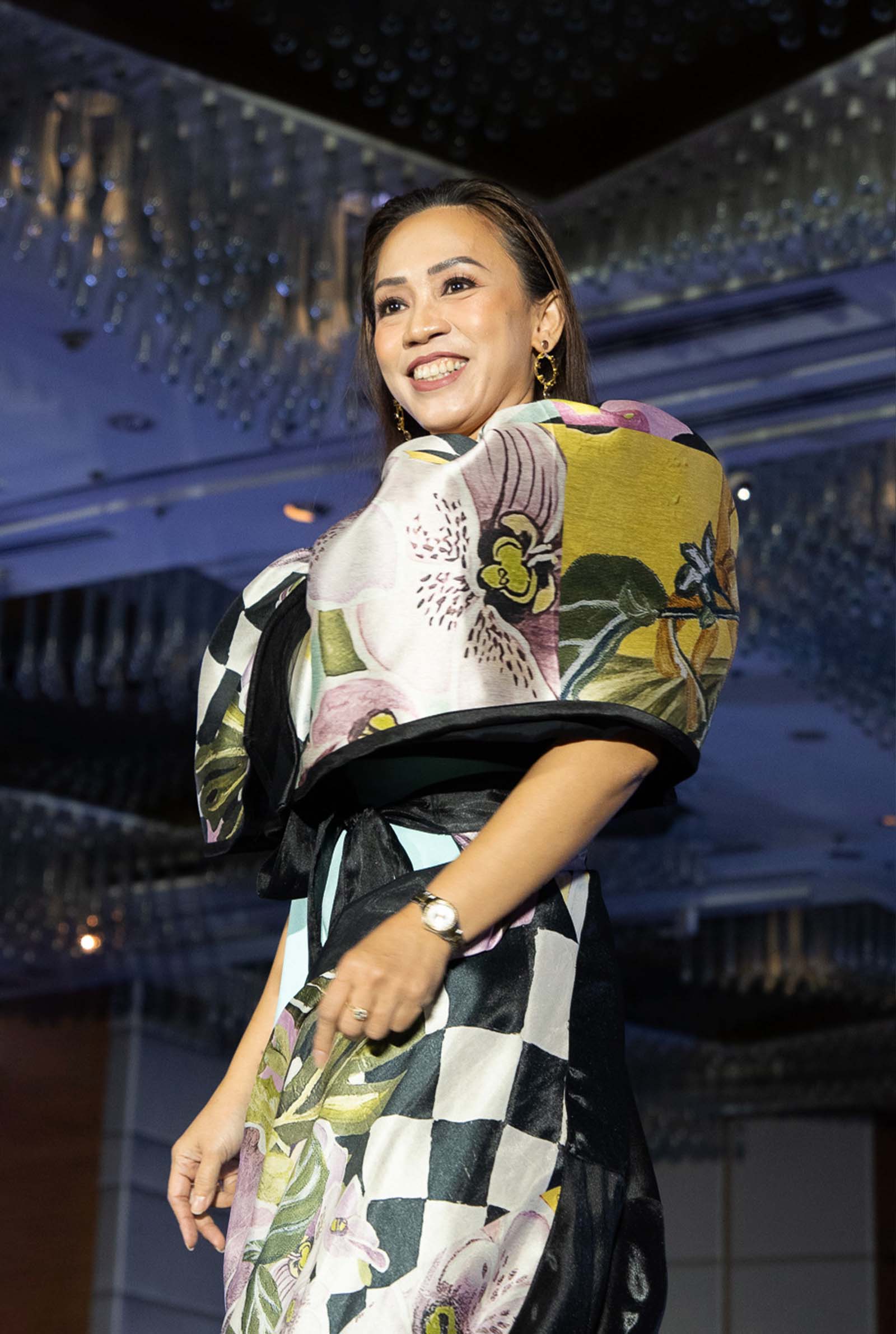 MME Indri P. Akyol, Spouse of Ambassador of Turkiye and SHOM Chairperson, wearing a reimagined Kimona with matching overskirt in a graphic floral print from Kultura.
