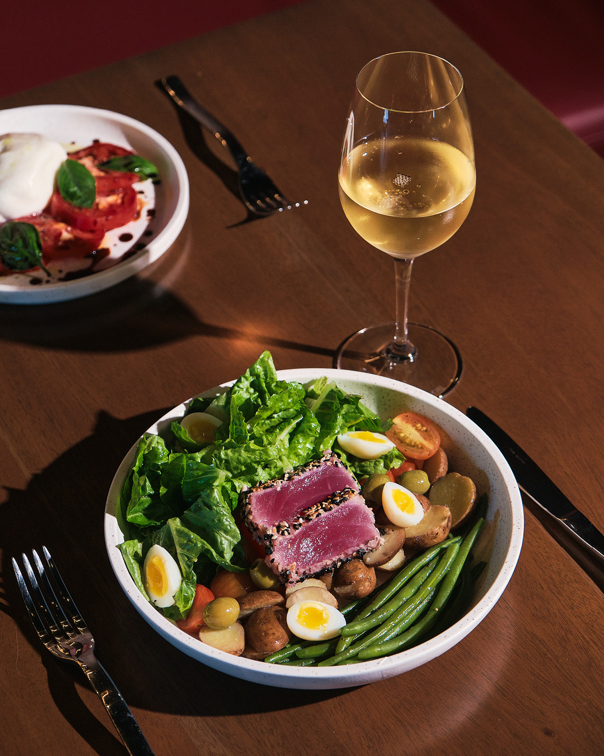 Salad Niçoise paired with a glass of white wine  Project Vino Reserve food wine restaurant Christmas holidays