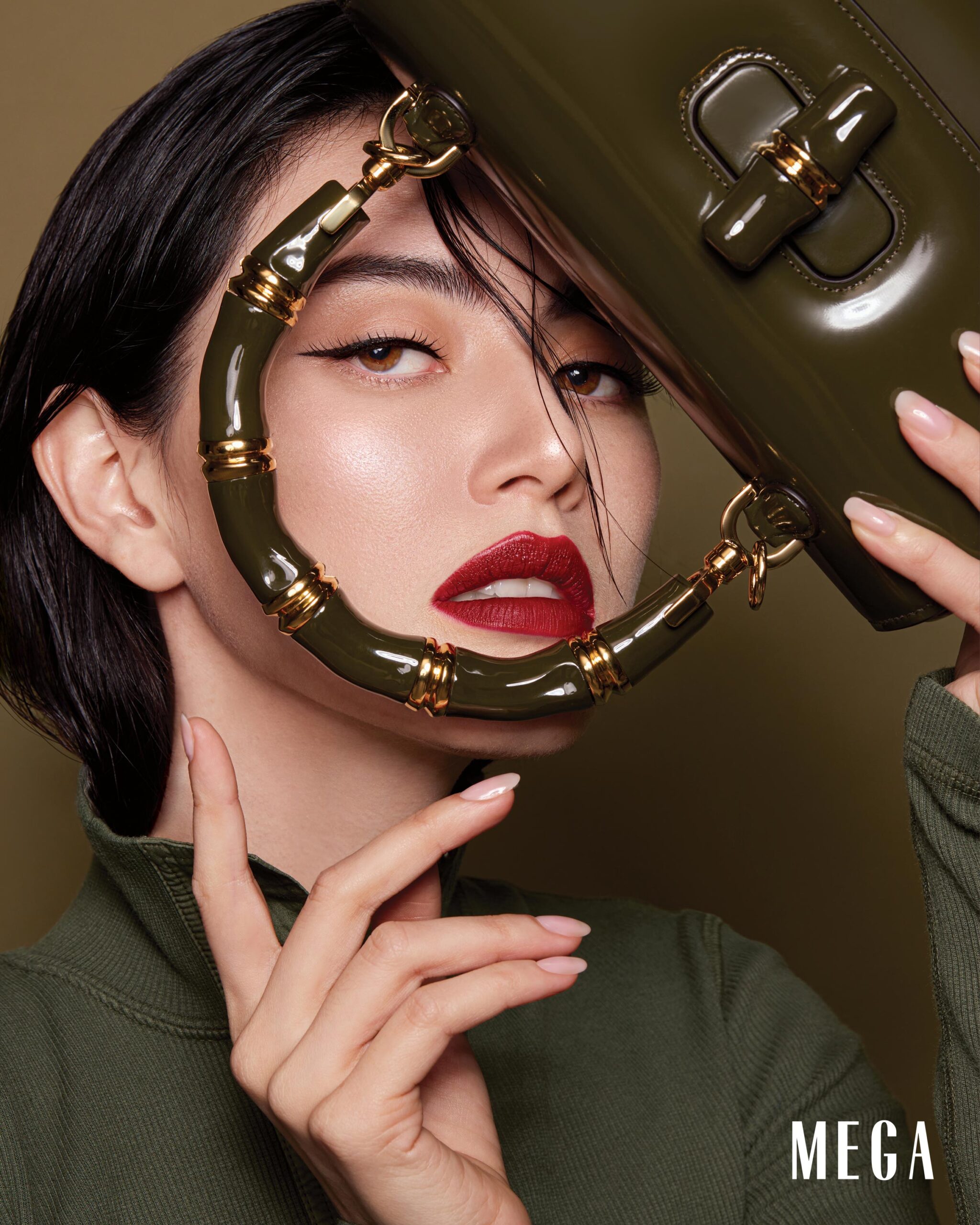 Davika Hoorne is wearing GUCCI Army green long sleeved knit top, with dark green small GUCCI Bamboo Diva handbag