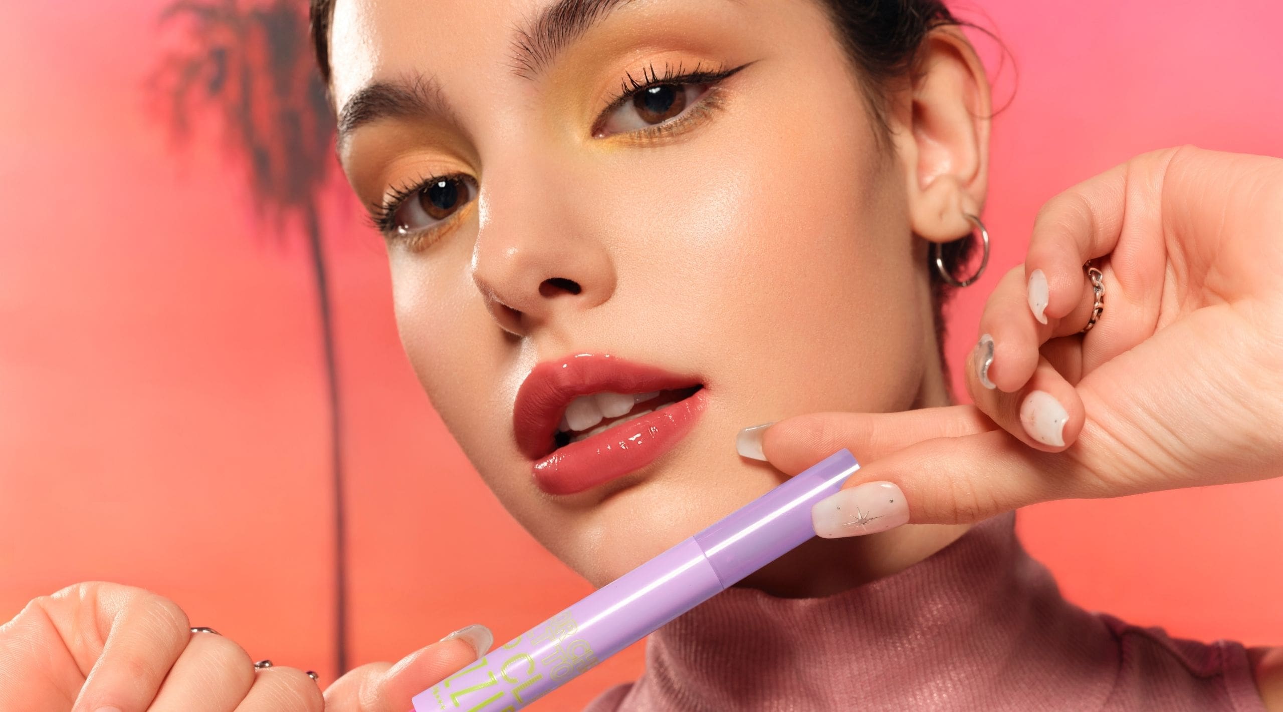 A model with her stick of Dazzle Me's Color Chrome Melt to Dew Click