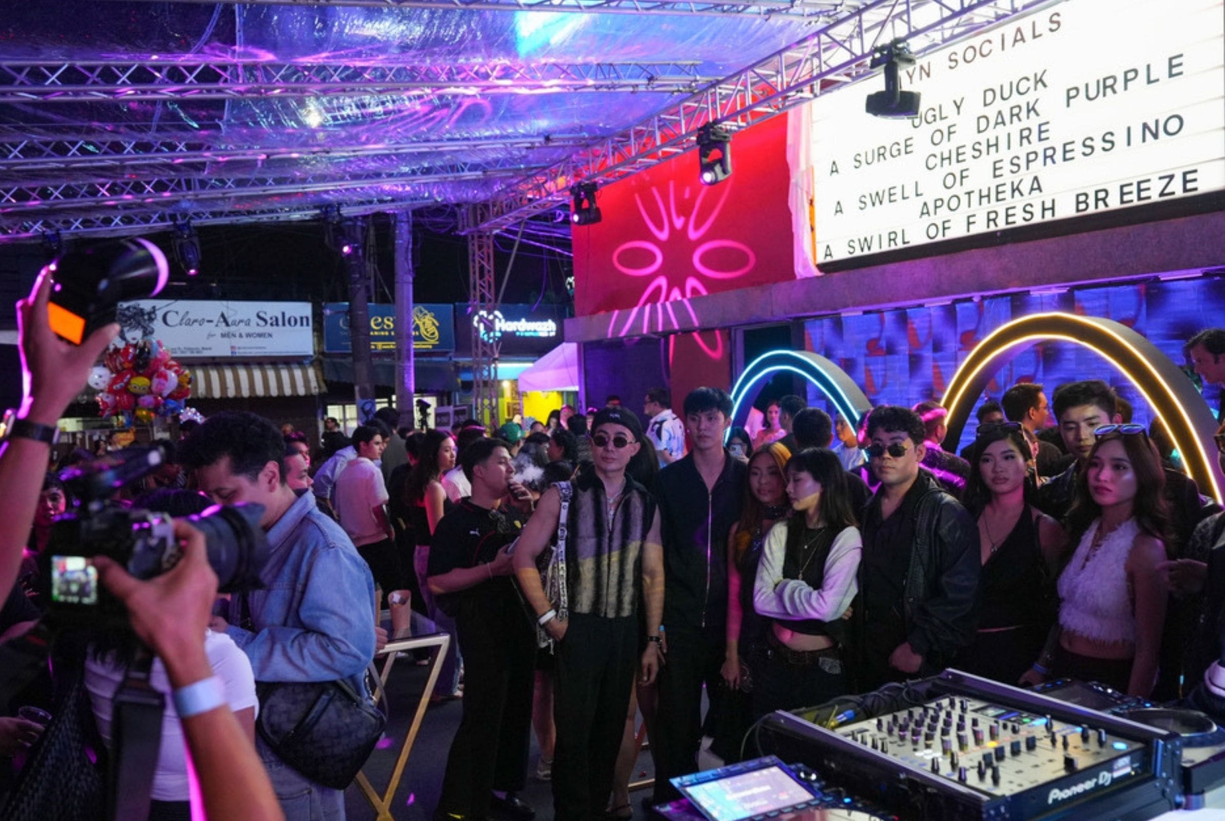 A crowd at the entrance of White Rabbit mingling in anticipation before entering.