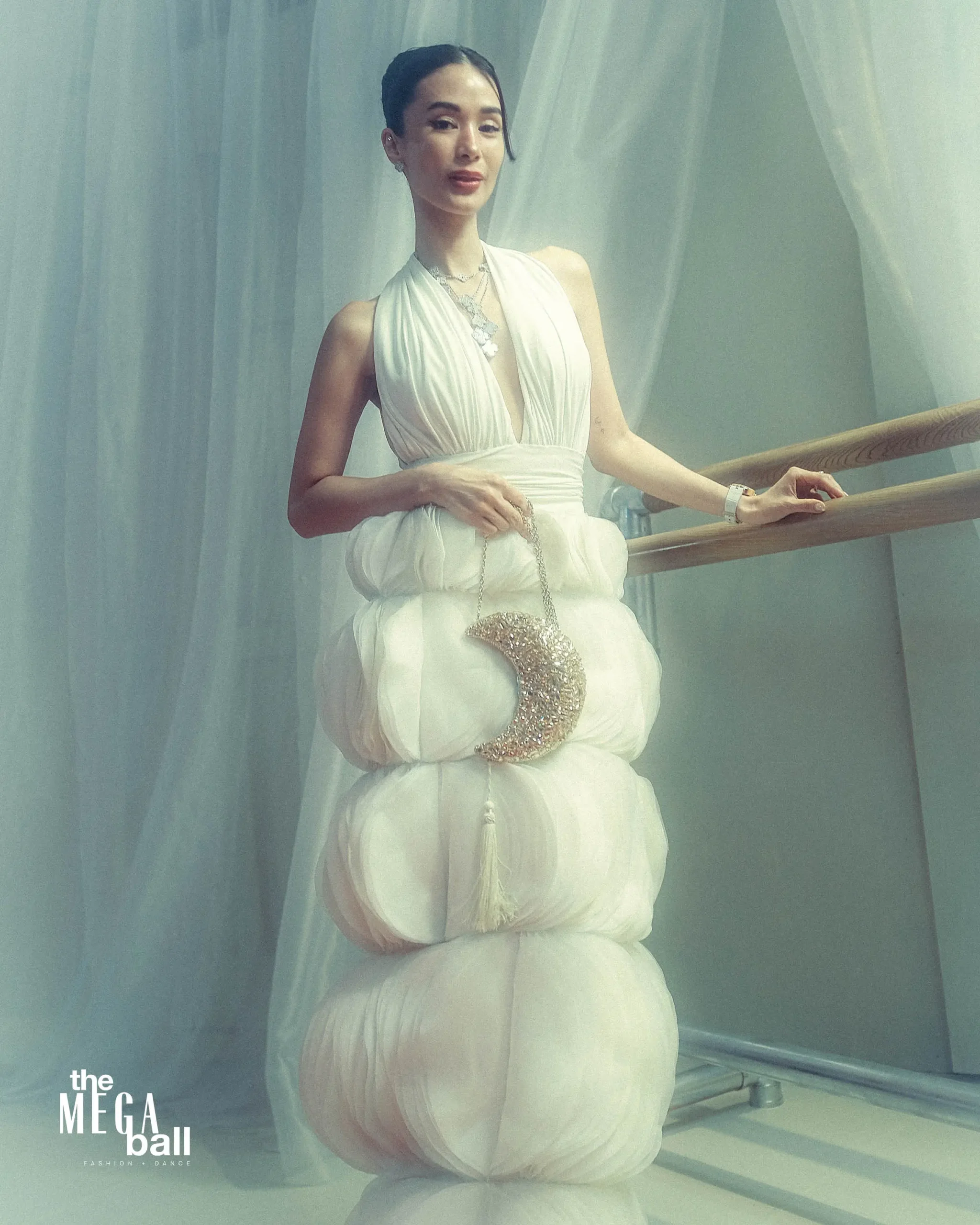 Evangelista’s bag accessory was a shimmering crescent-shaped judith lieber bag MEGA BALL 2025