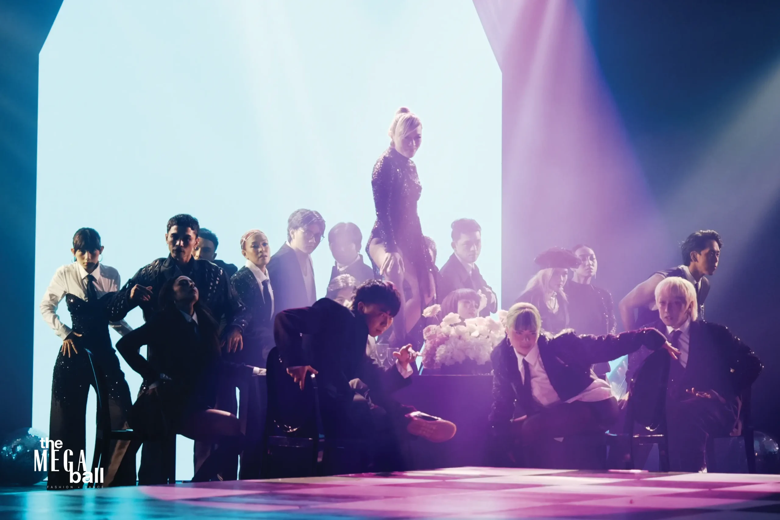 Teacher Georcelle and G-Force dance on, surrounding a table of flowers