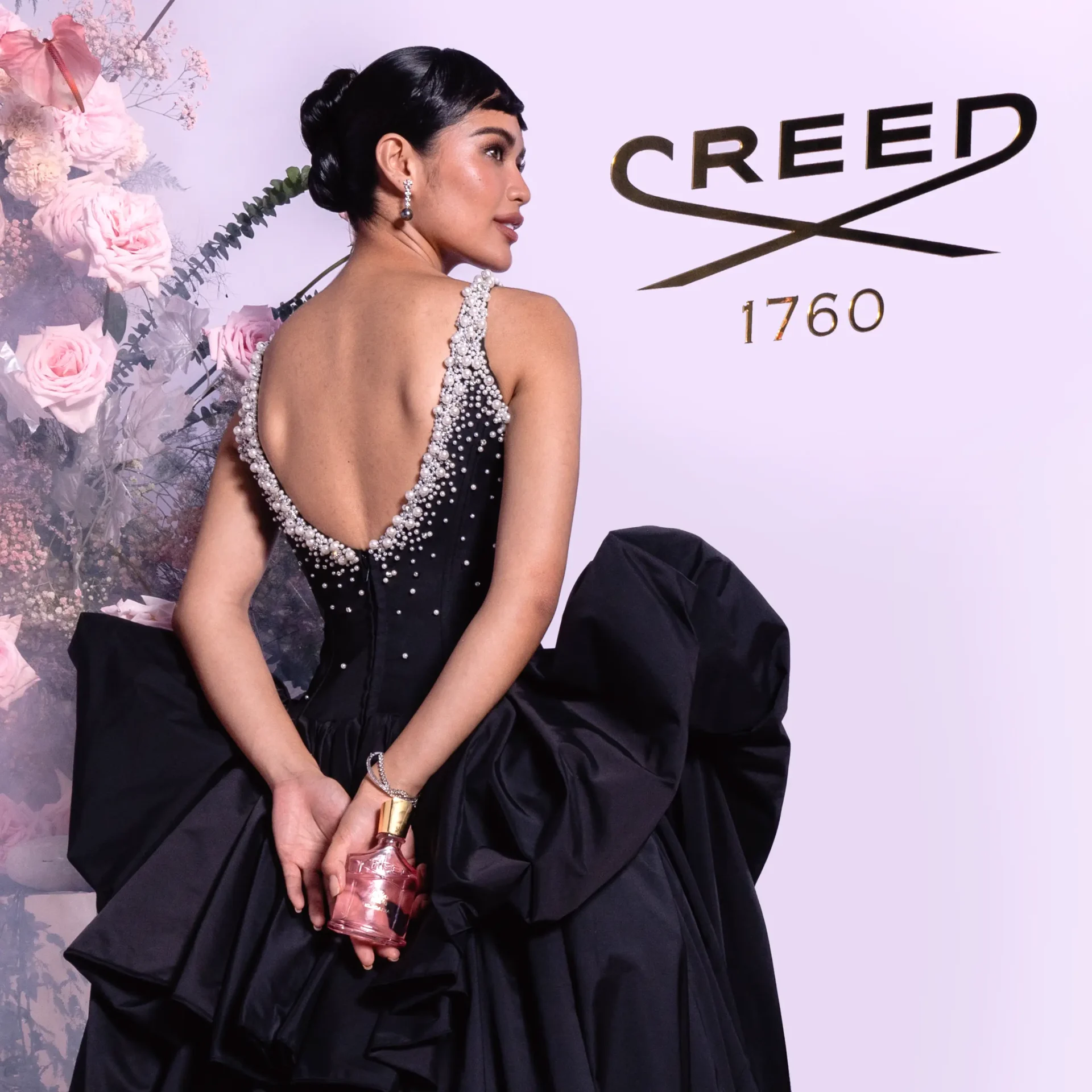 Krishnah Gravidez posed infront of Creed's immersive booth at the MEGA Ball 2025
