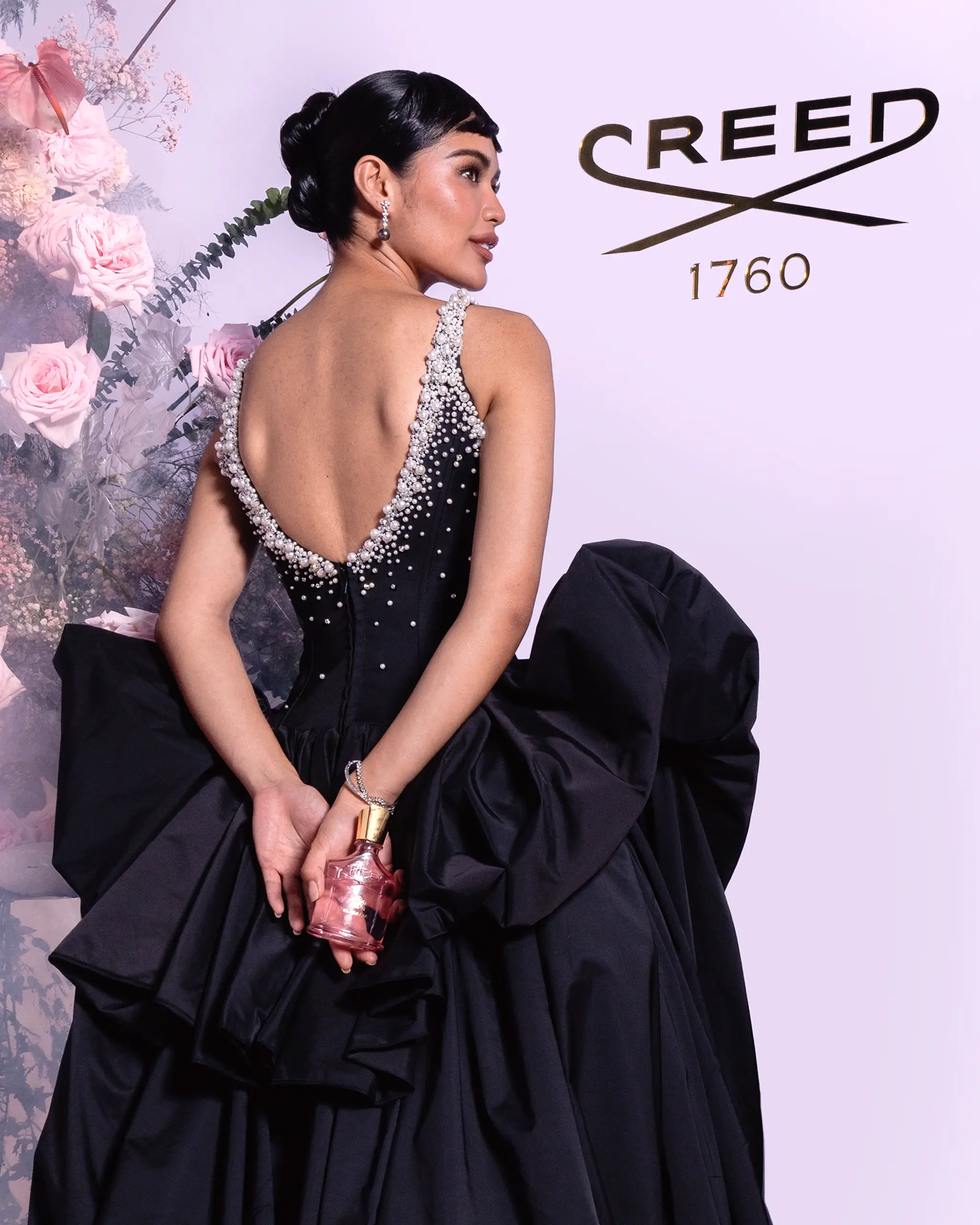 Krishnah Gravidez posed infront of Creed's immersive booth at the MEGA Ball 2025
