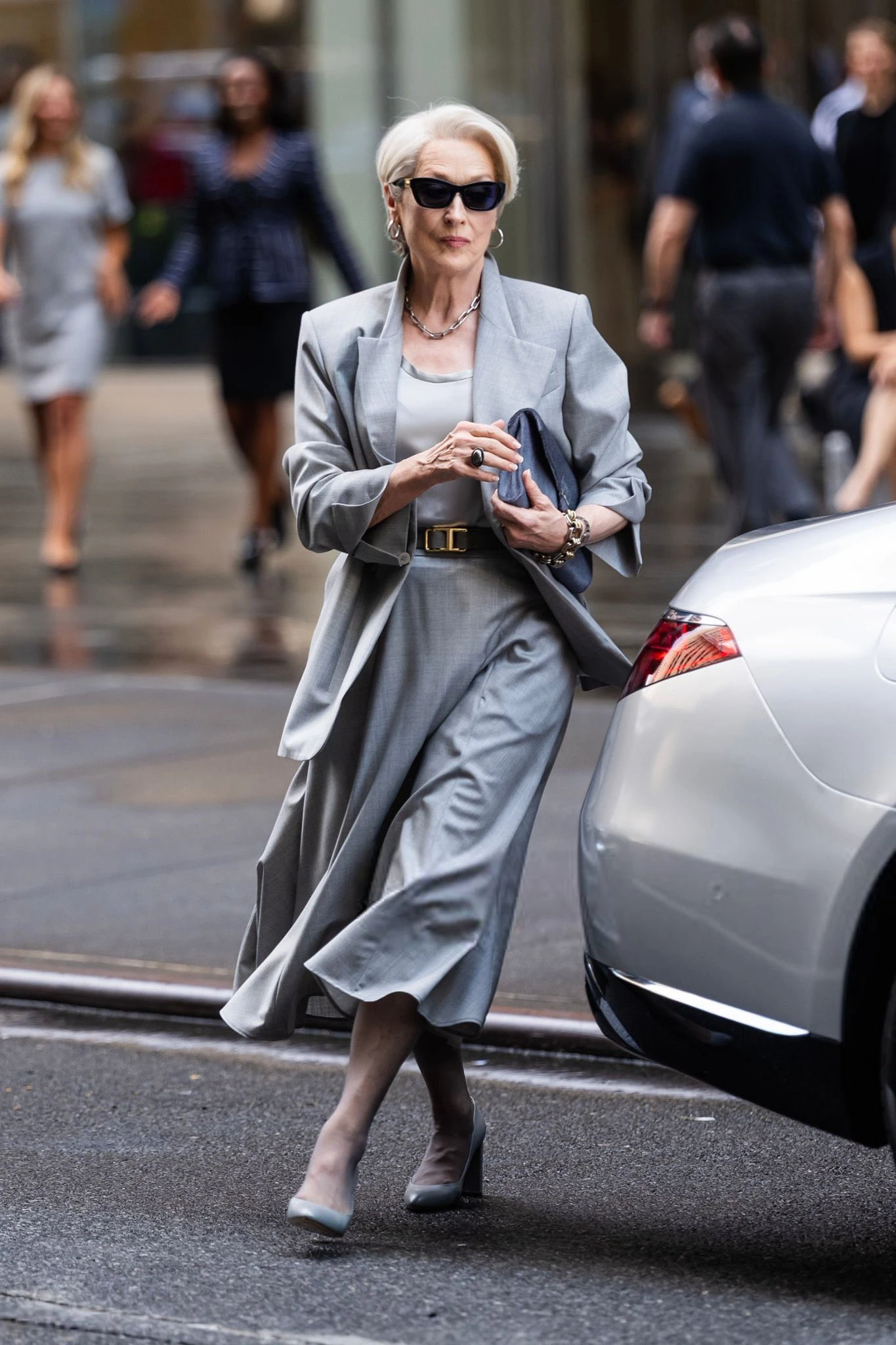 IN SASUPHI WOOL JACKST AND SKIRT, TOD’S BELT, and Deimille Grey Heels Devil wears Prada Miranda priestly