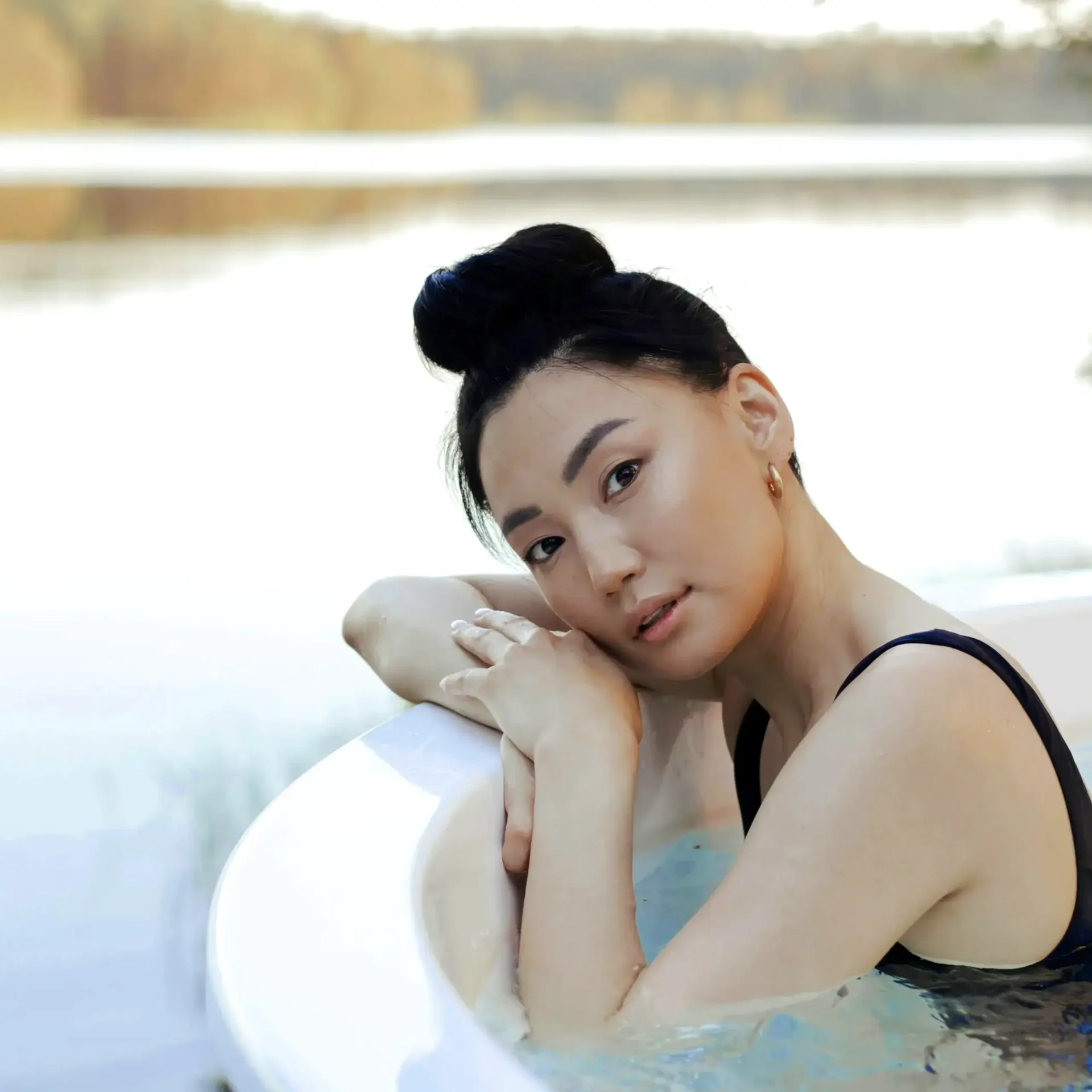 Overseas, a girl relaxes in her pool, given peace-of-mind thanks to her AMEX credit card