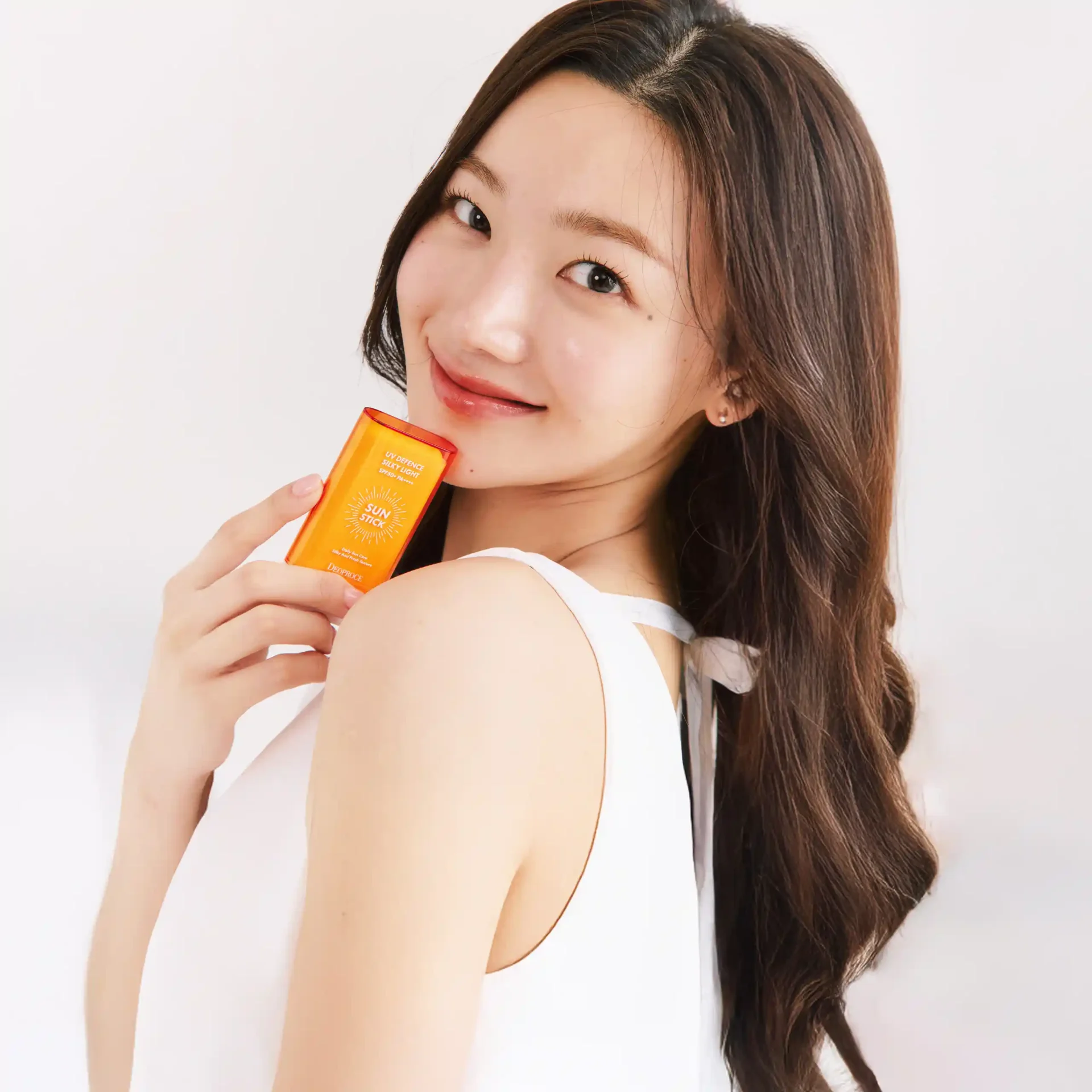 A girl with her UV Defence Silky Light Sun Stick SPF50+ PA++++