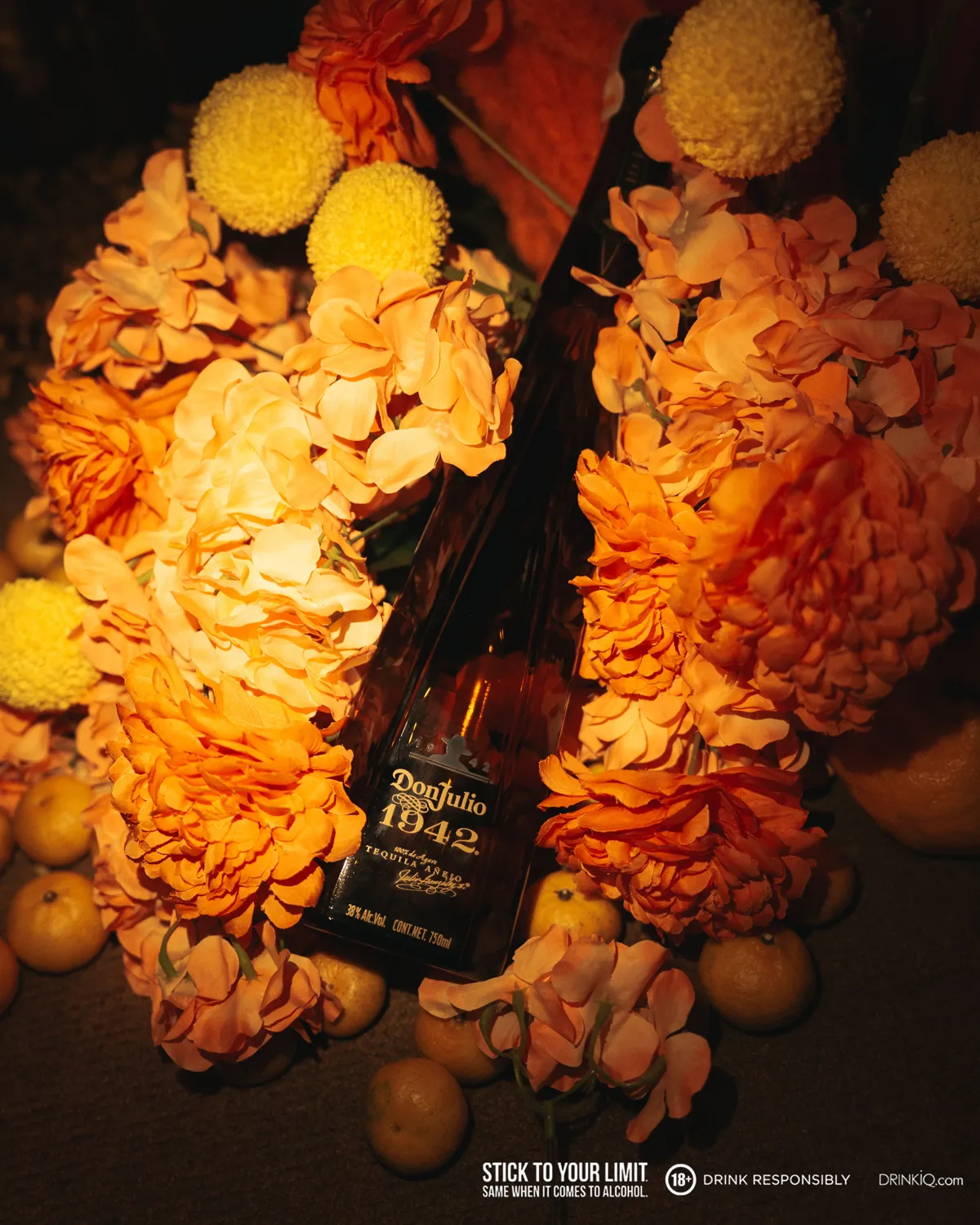 A bottle of Don Julio on a bed of flowers