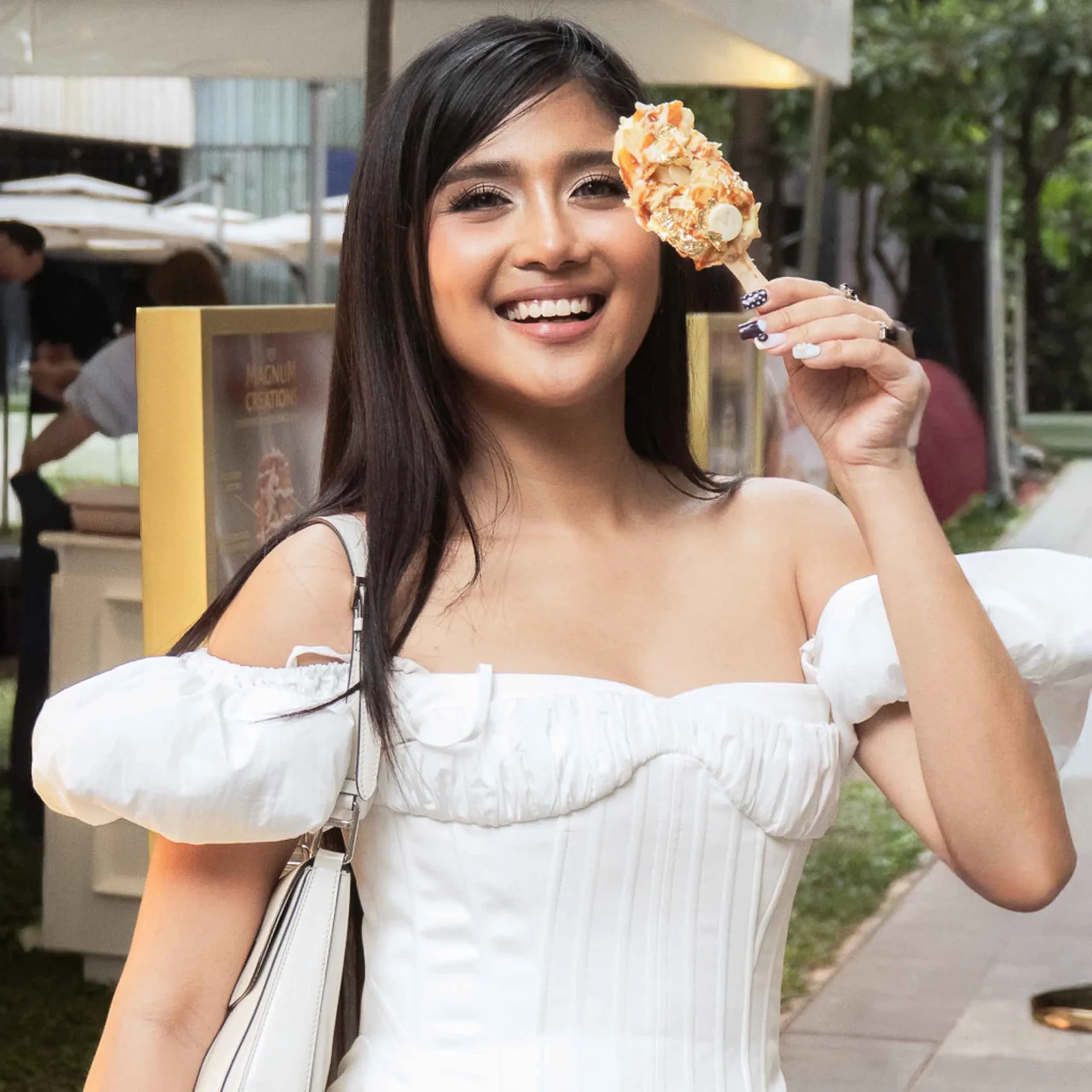 A woman posed with her Magnum bar.