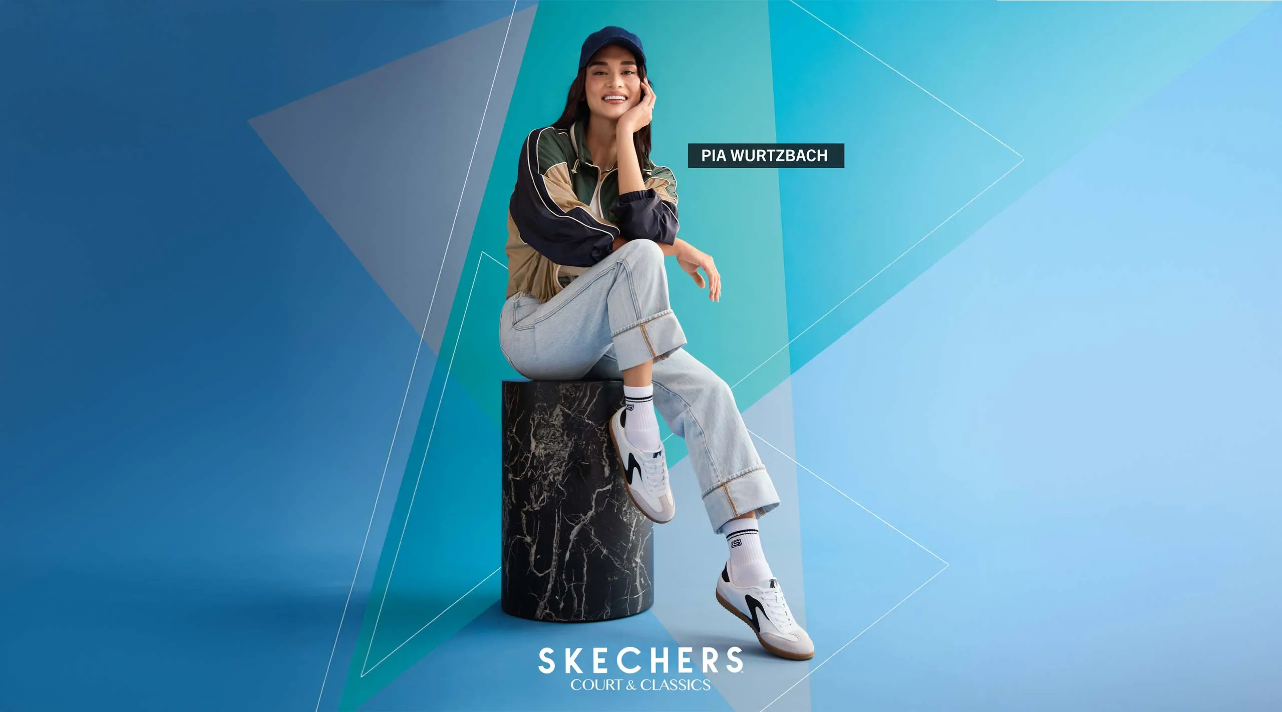 Pia Wurtzbach poses for Skechers, seated as she shows off the shoes.