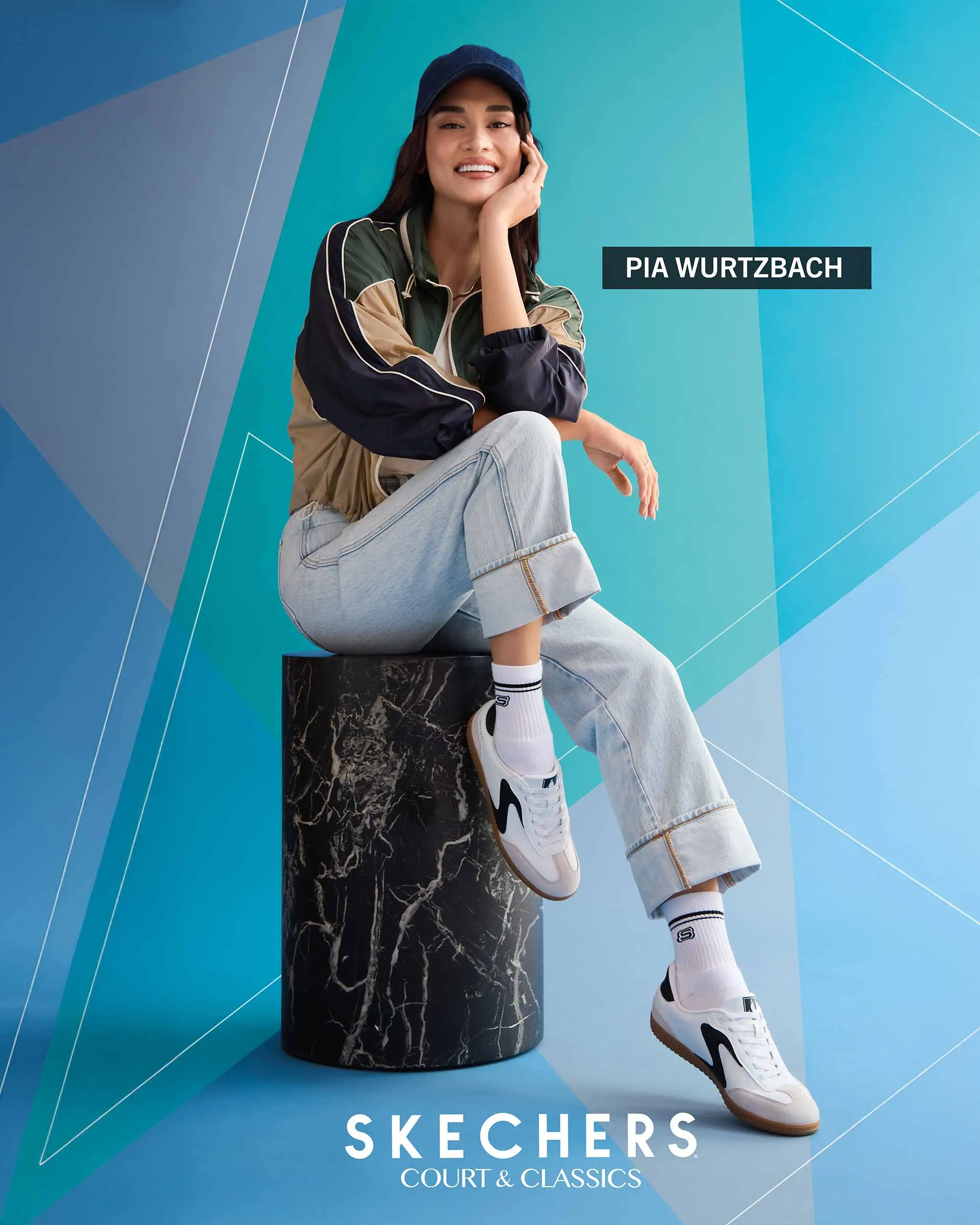 Pia Wurtzbach poses for Skechers, seated as she shows off the shoes.