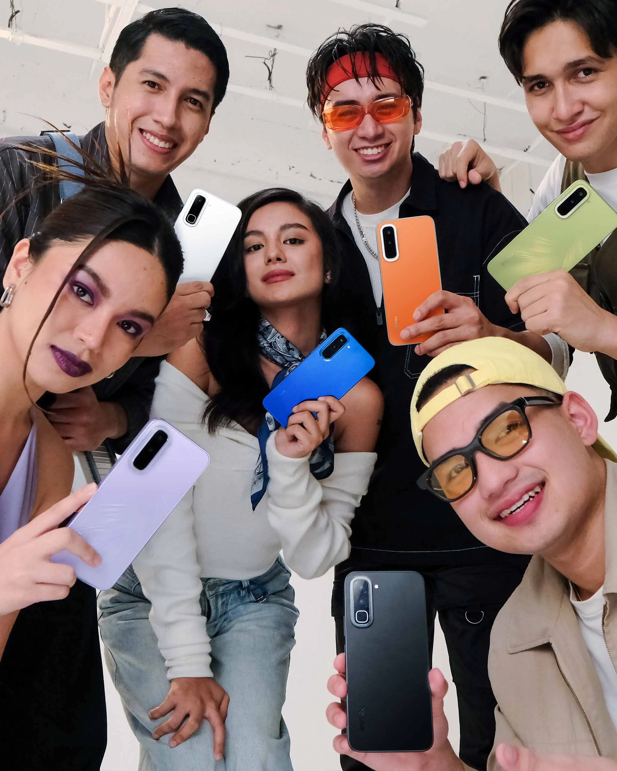 Young adults each holding a new variant for the Infinix HOT 70