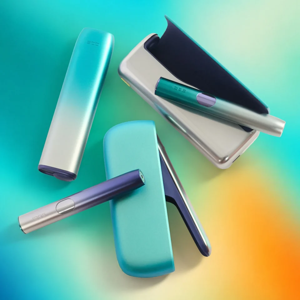 Close-up of blue and teal hair styling tools arranged on a turquoise background.