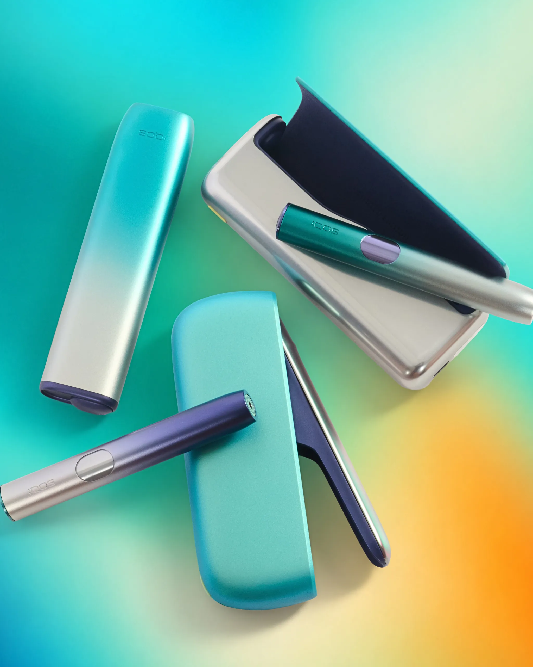 Close-up of turquoise and blue plastic tools arranged diagonally on a teal-to-yellow gradient background.