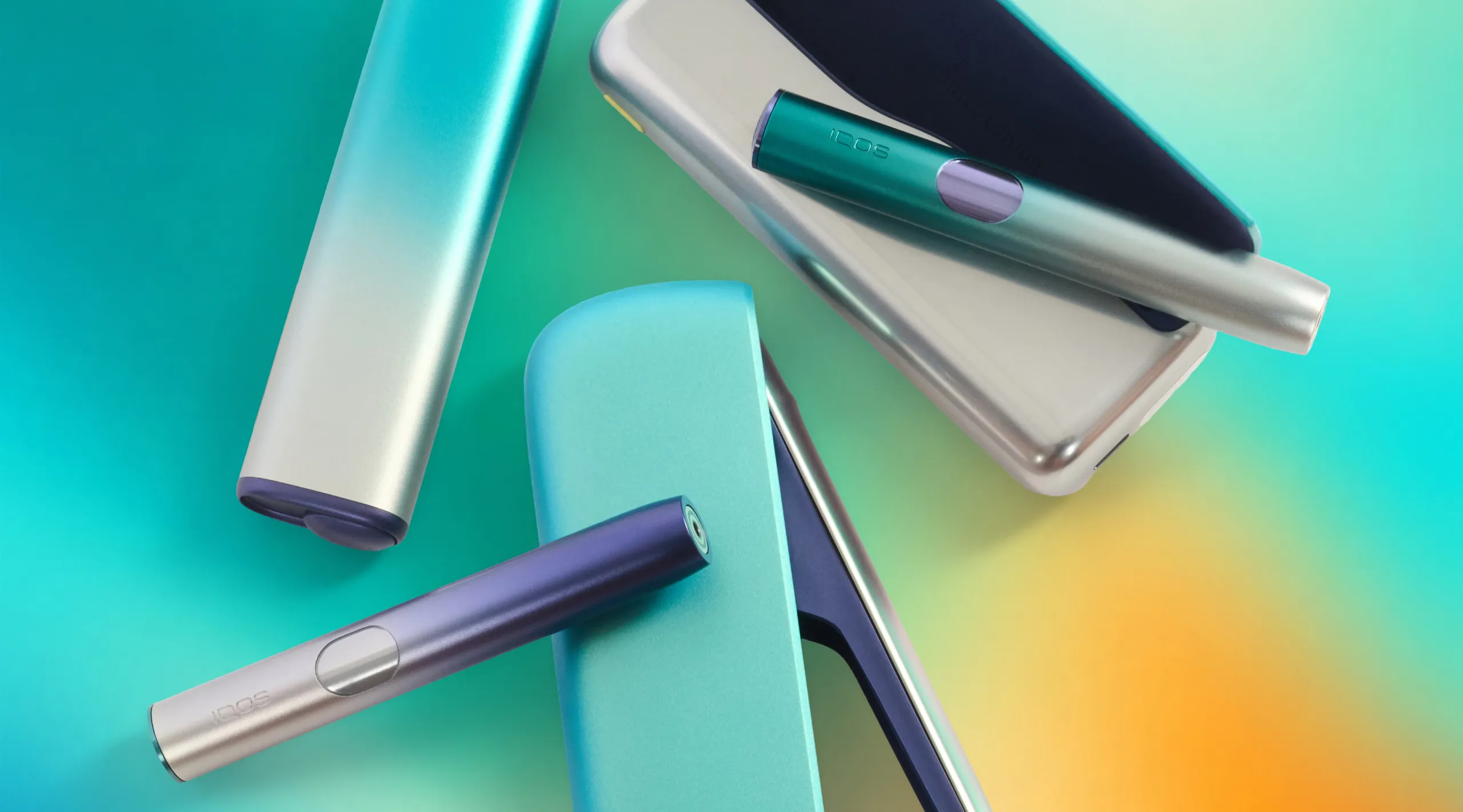 Close-up of a teal and silver mechanical device with cylindrical parts on a colorful gradient background.