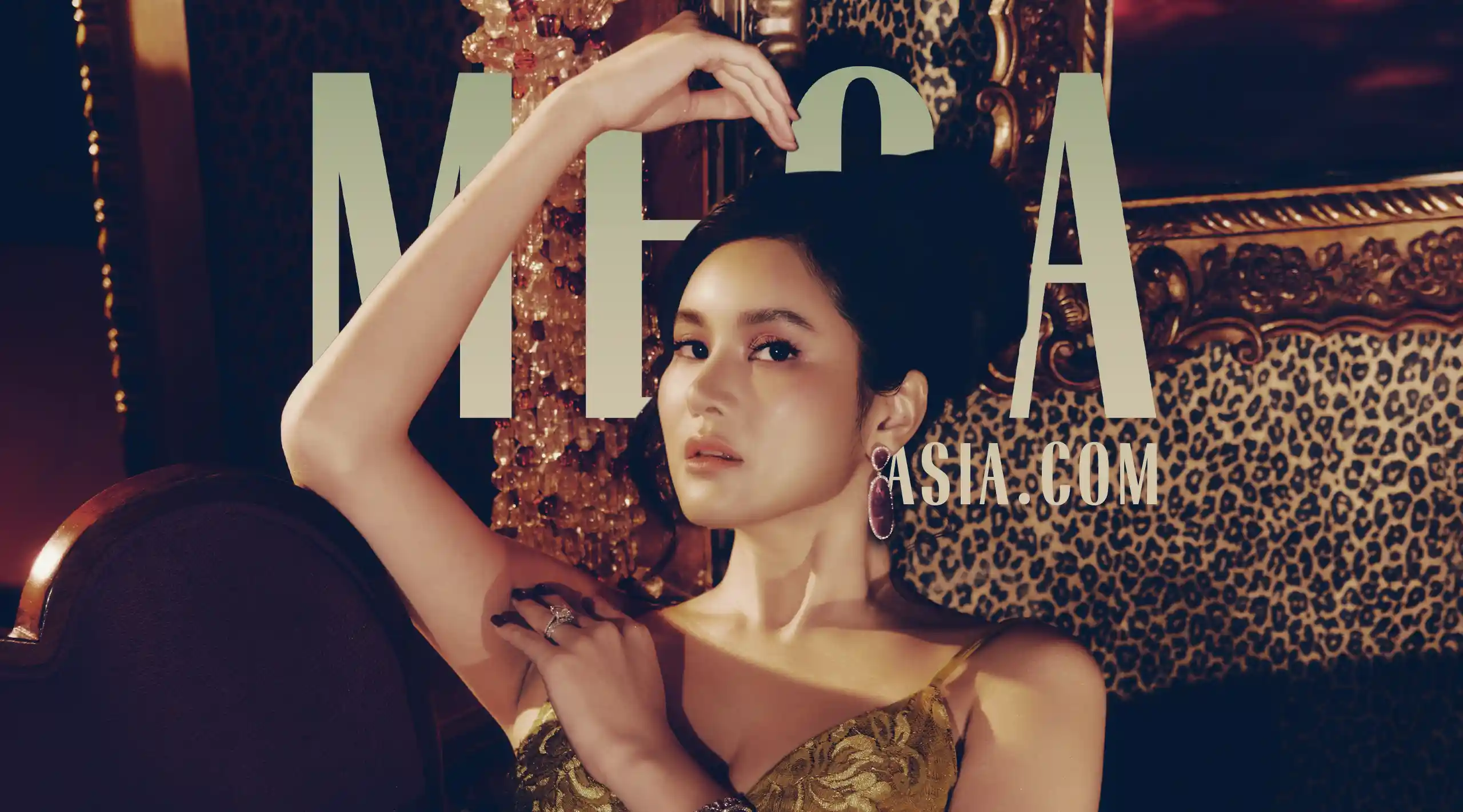 Fashion magazine cover featuring a stylish woman in a gold dress posed against a leopard-print backdrop with bold 'MENA' lettering in the background.