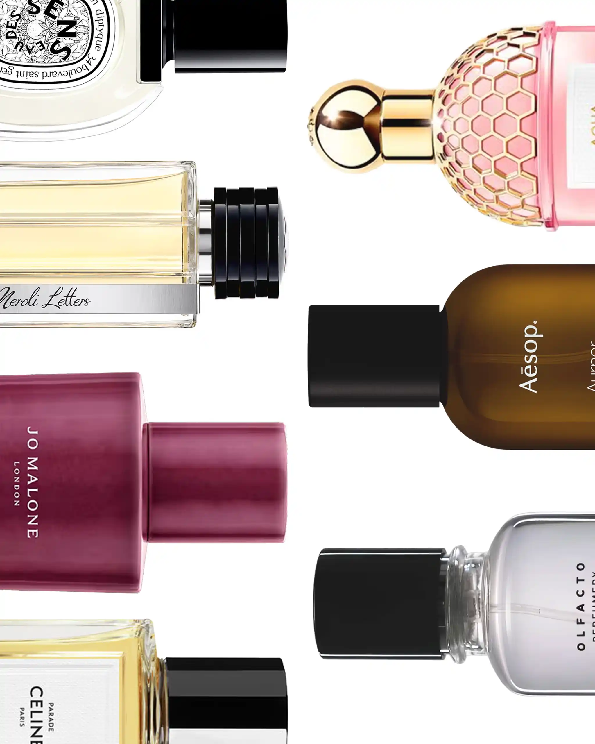 Assorted perfume and nail polish bottles arranged diagonally, showing pink, amber, and clear liquids against a white background.
